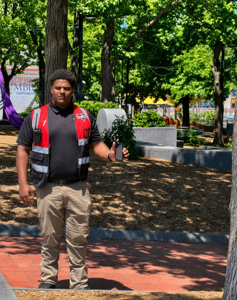 Professional unarmed security guard in uniform at a commercial property entrance